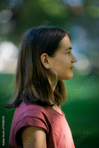 Captured in profile, the woman maintains a serene expression, exuding calmness and poise.