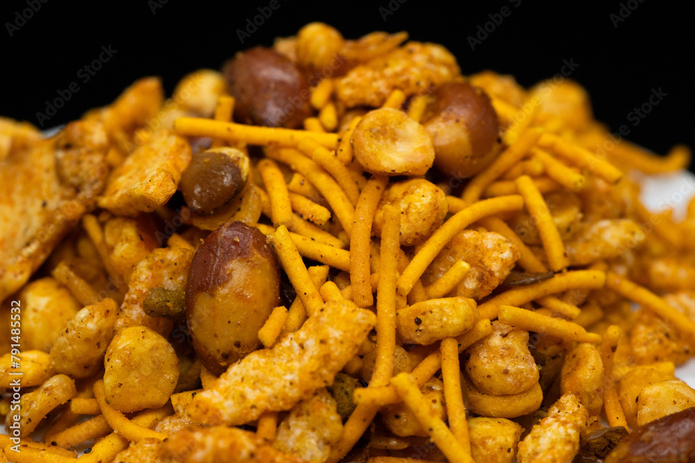 Hot spicy NavRatan mixture snacks in full-frame, made with, potato chips, peanuts, besan sev, red chili. Pile of Indian spicy snacks (Namkeen) Hot spicy NavRatan mixture snacks in full-frame, made with, potato chips, peanuts, besan sev, red chili. Pile of Indian spicy snacks (Namkeen)