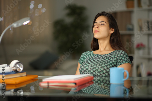 Student relaxing in the night breathing at home