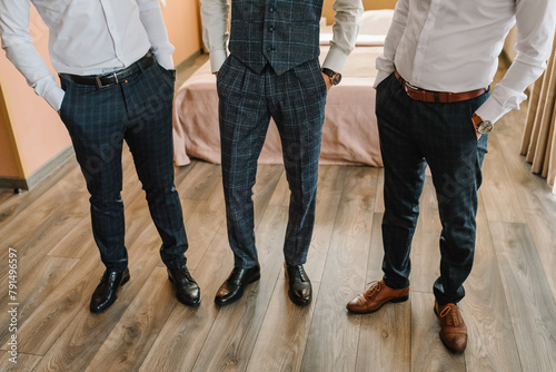 Grooms and groomsmen feet. Fashion, style, beauty. Lifestyle. Men trousers. Best men look. Closeup man shoes. Top view men stylish black and brown shoes. Young men in suits. Bottom view of the floor.