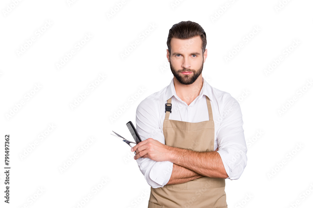 Portrait with copy space, empty place of virile harsh barber having his arms crossed, holding equipments in hand, looking at camera, isolated on grey background Portrait with copy space, empty place of virile harsh barber having his arms crossed, holding equipments in hand, looking at camera, isolated on grey background