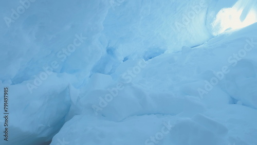 Ice, Snow Covered Cave of Antarctica. Winter Landscape. Snowdrifts, Ice Surface Inside of the Glacier Grotto. Stunning Polar Scene of Wild Untouched Nature. Antarctic Continent.