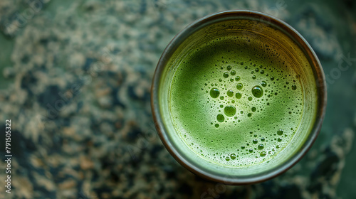 Top-down view of a fresh matcha tea in a ceramic mug  depicting the rich texture and vibrant green of the beverage