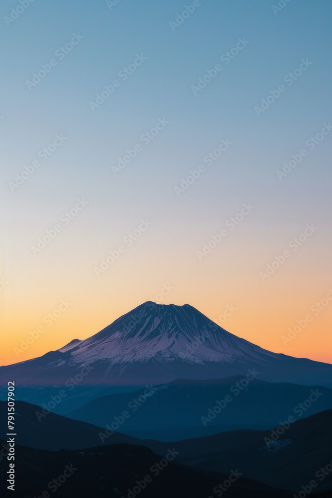Silhouette of a single mountain peak against a clear sky during sunrise or sunset, with clean lines and negative space emphasizing the majesty of the natural landscape. 