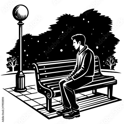 Es de noche un hombre sentado en una banca solitaria sin nadie más al rededor photo