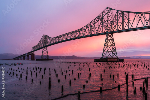 Scenic view of Astoria-Megler Bridge silhouetted against a colorful sunset sky photo