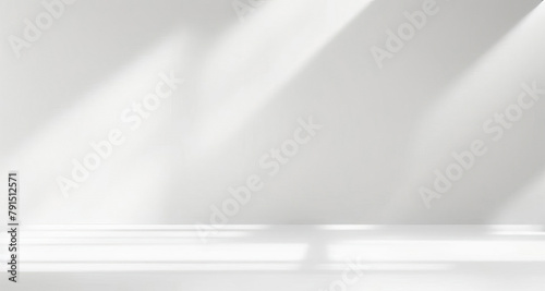 Minimal abstract light gray background for product presentation. Soft shadow and light from windows on white wall. © Laura Pashkevich