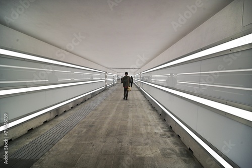 perspective view of a long illuminated underpass almost deserted