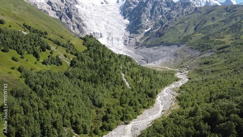 Pull back drone footage of the scenic Adishi Glacier and Chkhunderi Pass in Adishi village, Georgia photo