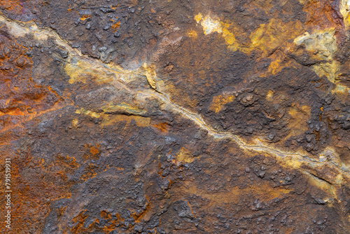 A macro shot of a rock at a close distance. Showing extreme detail and minerals that are in the rock.