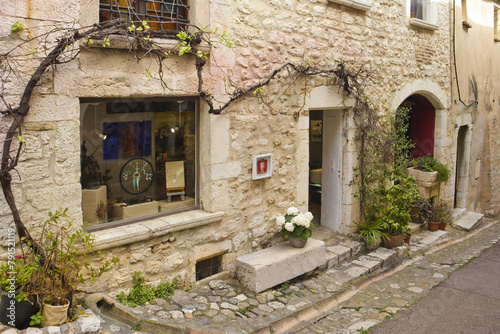Fototapeta Naklejka Na Ścianę i Meble -   Narrow street of downtown in french village Saint-Paul-de-Vence, France
