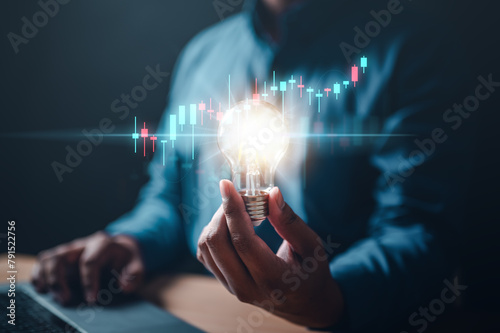 chart, graph, invention, bulb, invest, leadership, marketing, solution, strategy, glowing. A person is holding a light bulb. Concept of innovation and creativity with new ideas and inventions. © Day Of Victory Stu.