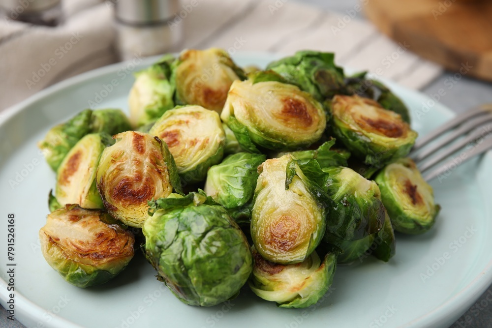 Obraz premium Delicious roasted Brussels sprouts on table, closeup