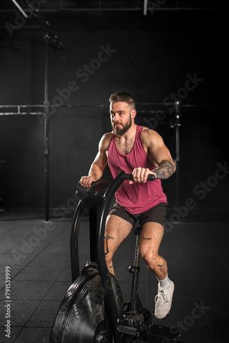 Man exercising on elliptical cross-trainer machine, wearing activewear. Routine workout for physical and mental health.
