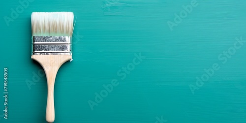 Paintbrush on an empty turquoise background, with copy space for photo text or product, blank empty copyspace symbolizing the idea