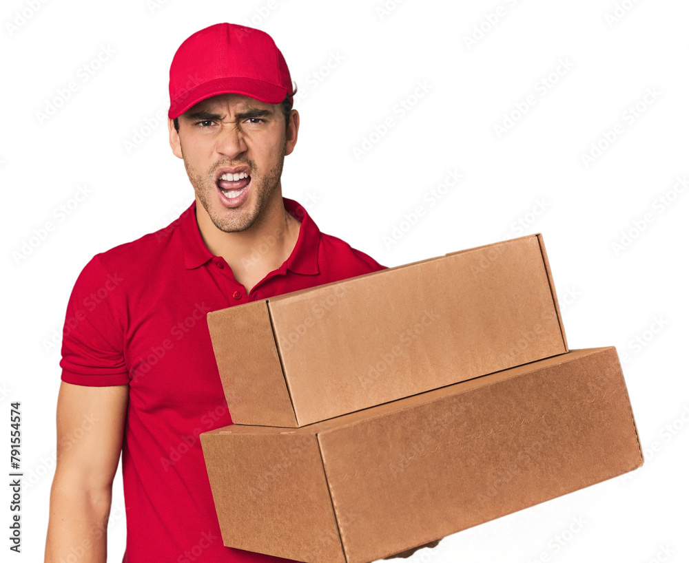 Young Hispanic delivery man with boxes screaming very angry and aggressive. Young Hispanic delivery man with boxes screaming very angry and aggressive.