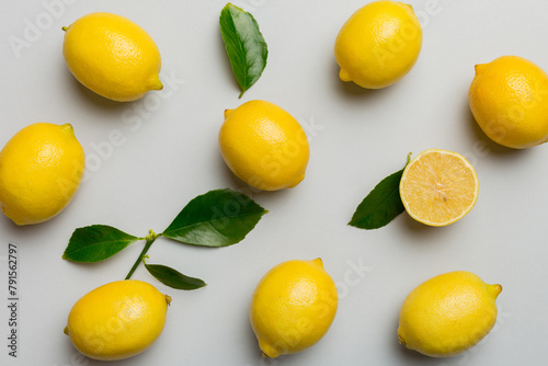 Many fresh ripe lemons as colored background, top view. Elegant background of lemon and lemon slices Top view flat lay