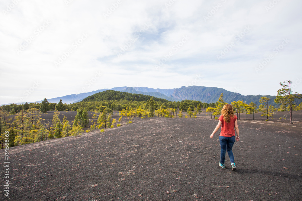 Obraz premium Young woman and sunset in Llano del Jable, La Palma, Canary islands.