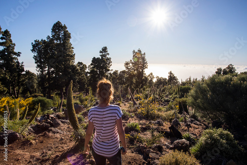 Young woman and sunset in Roque De Los Muchachos in Caldera de Taburiente, La Palma, Spain photo
