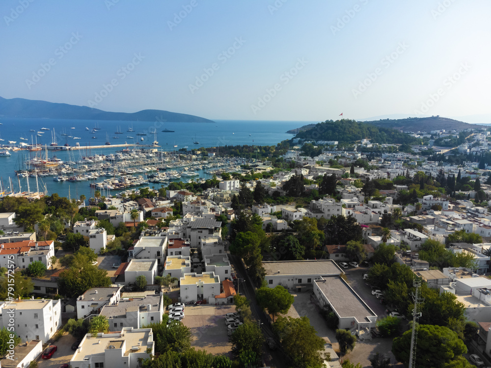 Drone view of the charming city of Bodrum, marina with yachts on a sunny day. Beautiful urban landscape of Bodrum, Turkey.
