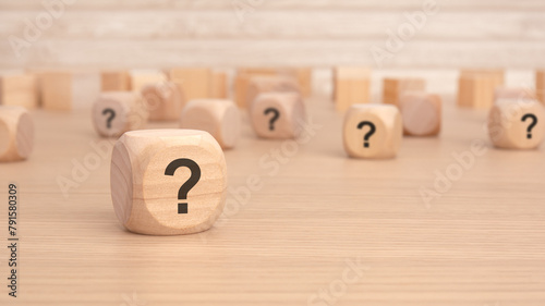 wooden cubes with a question mark engraved on them, front view