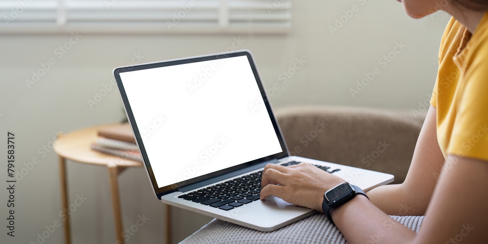 Naklejka premium Young female with laptop at home on white blank screen for montage mockup display device in concept of lifestyle work at home