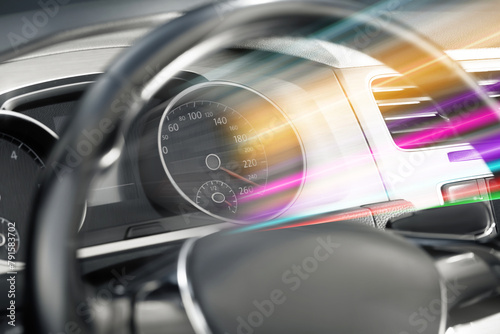 Speedometer behind steering wheel in car, motion blur effect © New Africa