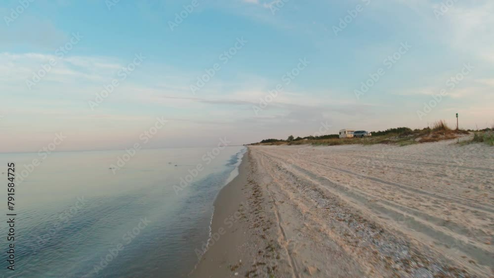 Running along the water's edge on the seashore in the early summer morning. POV Running along the water's edge on the seashore in the early summer morning. POV