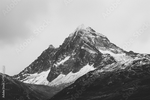 A black and white image of a mountain peak  accentuating its stark beauty.