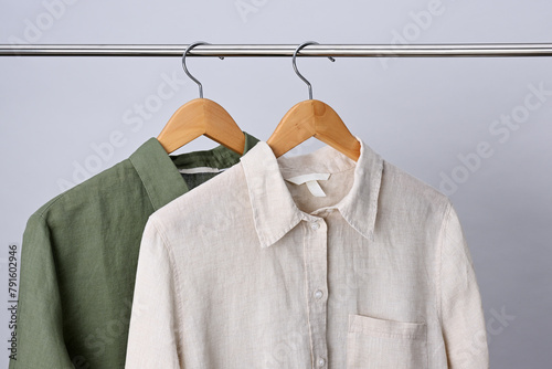 Linen shirts hanging on wooden hangers