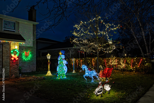 Christmas lights holiday decoration. Illuminated windows, house and christmas trees in night. Burlington, Ontario, Canada