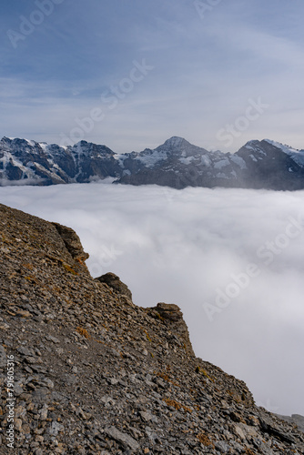 View of Swiss Alps over clouds on a bright sunny day from Schilthorn summit in Switzerland