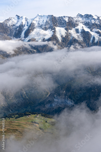 View of Lauterbrunnen valley in Swiss Alps. Bright sunny day with low clouds in Switzerland