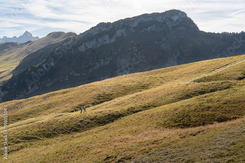 People walking on a ridge of a mountain in Stoos, Switzerland. Swiss Alps iconic aerial view