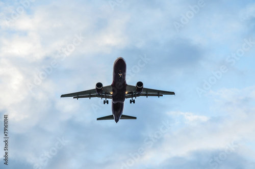 A plane in the sky with clouds