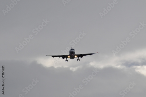 A plane in the sky with clouds