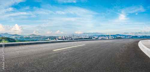 Asphalt highway road and city skyline with green mountain scenery in Shenzhen. Panoramic view. © ABCDstock