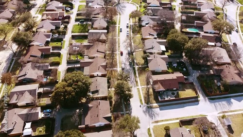 Flyover subdivision suburban neighborhood with multiple cul-de-sac dead-end residential street shapes like keyholes outside Dallas DFW, Texas, aerial view single family houses swimming pools. USA photo