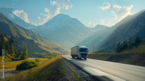 A large truck carries cargo along a highway through beautiful mountains photo