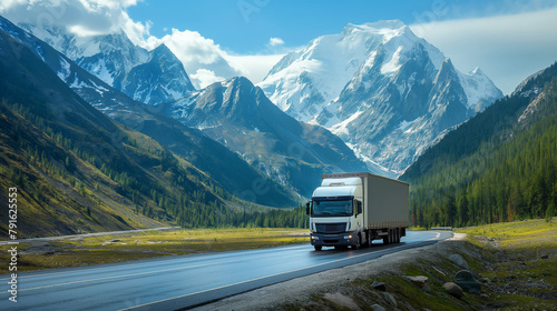 A large truck carries cargo along a highway through beautiful mountains photo
