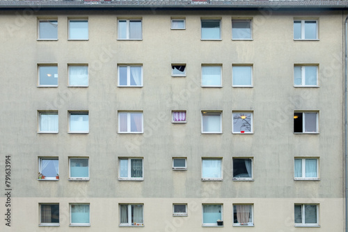 grey dirty facade of a family living apartment house