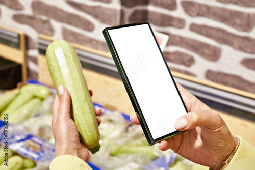 Zucchini vegetable in store and smartphone isolated white © Sergey Ryzhov