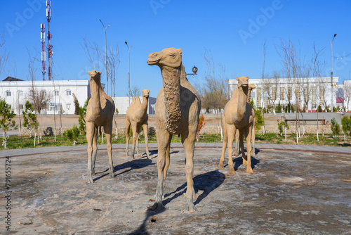 Statue of a camel herd in front of the Regional History and Aral Sea Museum of Moynaq (Muynak) in Karakalpakstan, in the west of Uzbekistan photo