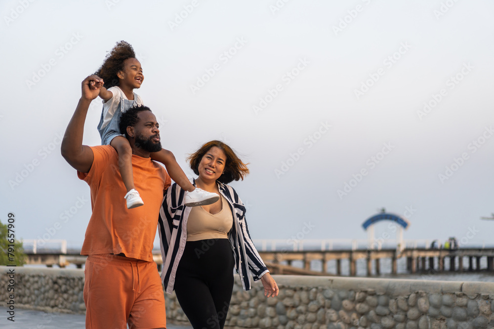Portrait of enjoy happy love black family.play, having fun, daughter, parenthood, care, superhero.african american father and mother with little african girl child smiling moments good time at home