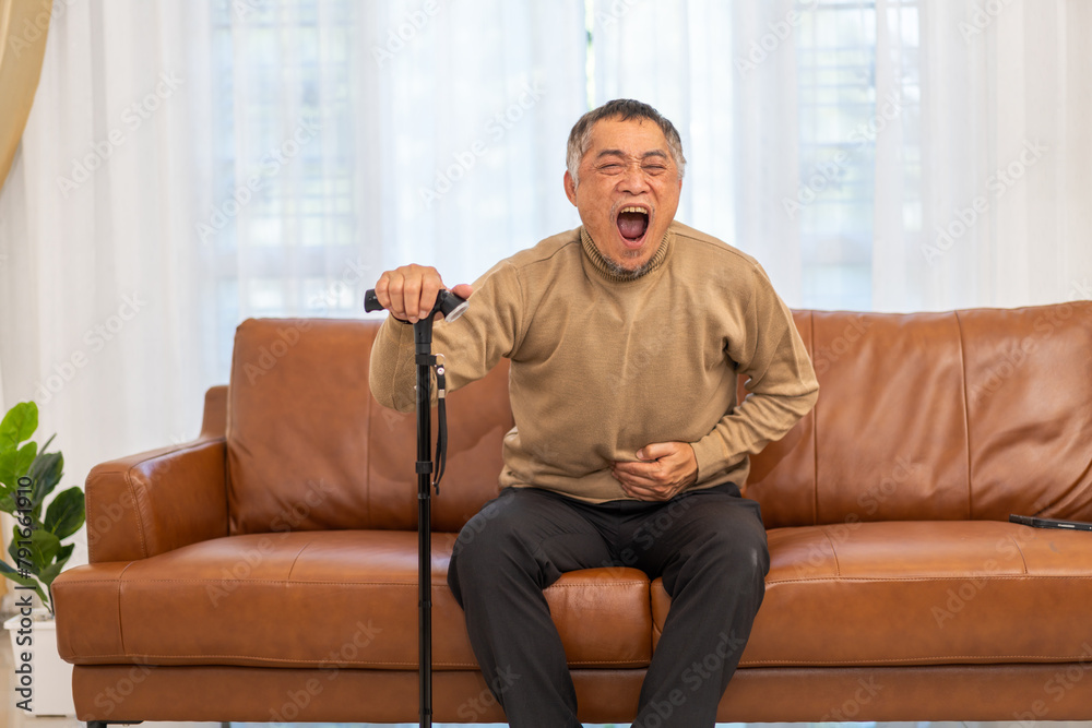 Senior asian elderly man sick unhappy touching belly stomach with suffering from stomach ache pain, gastritis, gastroenteritis, food poisoning, diarrhea, intestinal inflammation at home