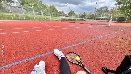 A tennis court, tennis racket and a tennis ball