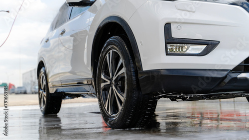 car at a self-service car wash covered in foam