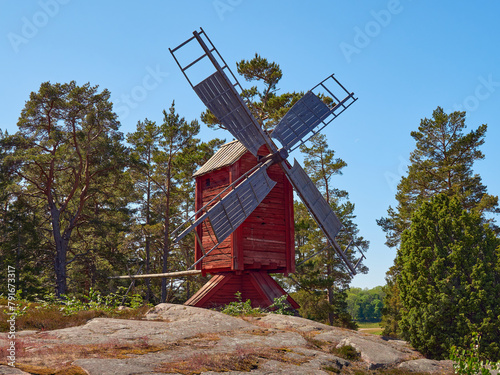 Traditional windmill on a rocky hillside near Kastelholm Castle on the Åland Islands in summer day. photo