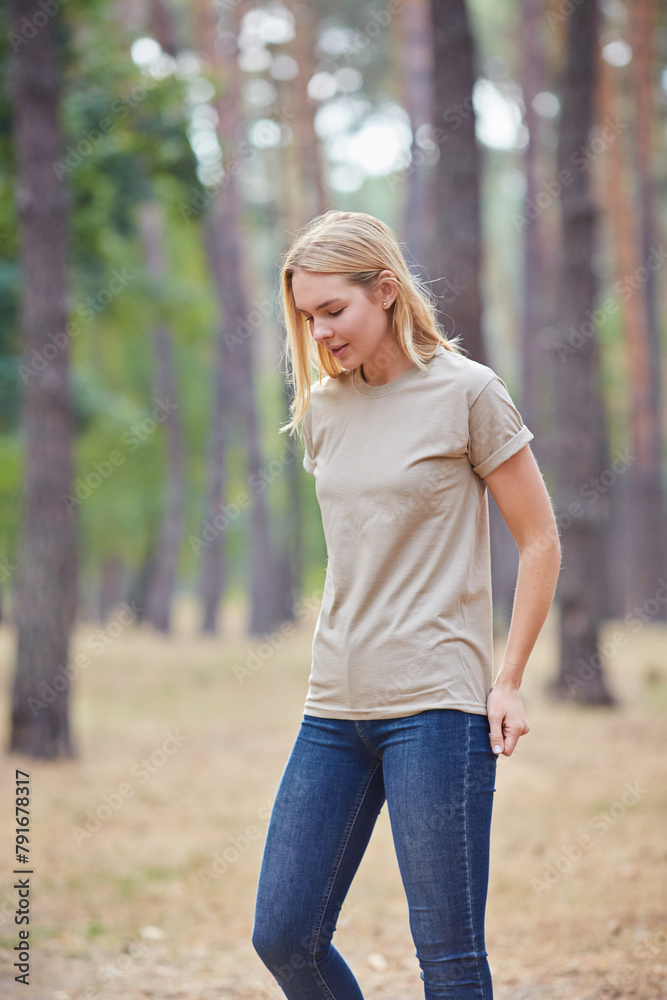 Attractive blue eyed blonde woman walk on the city park. Girl wear beige t-shirt, pink bag and look happy and smiles. Attractive blue eyed blonde woman walk on the city park. Girl wear beige t-shirt, pink bag and look happy and smiles.