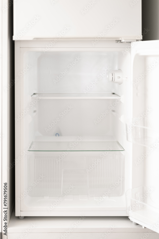 The open refrigerator is empty. The open refrigerator is empty.